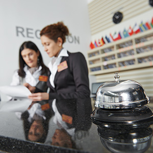 Hotel reception desk workers checking packages