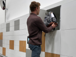 Person retrieving backpack from locker